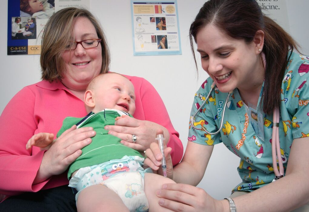 a woman holding a baby in a hospital room